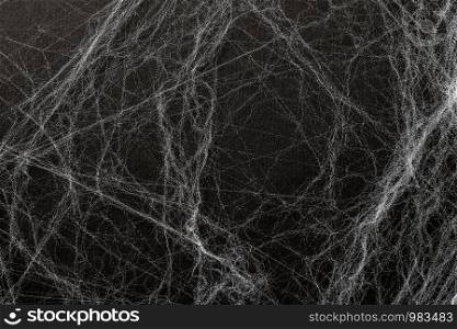 Artificial cobweb or spaider web on a black background. Abstract background. Top view, concept Happy halloween.. Artificial cobweb or spaider web on a black background. Abstract background. Top view, concept Happy halloween