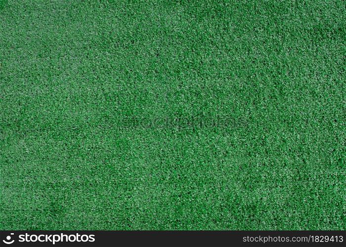 Artificial grass texture background. Top view of green lawn sport background.
