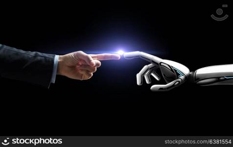 artificial intelligence, future technology and business concept - robot and human hand with flash light over black background. robot and human hand flash light over black
