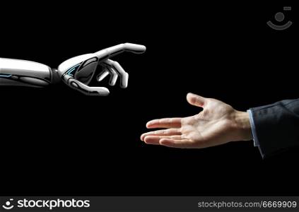 artificial intelligence, future technology and communication concept - robot and human hand over black background. robot and human hand flash light over black. robot and human hand flash light over black