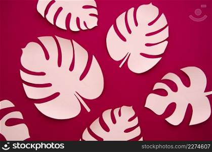 artificial leaves paper cut style with burgundy background