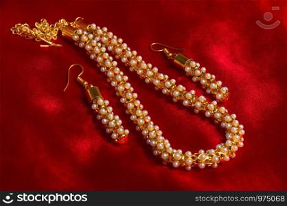 Artificial necklace set on red background
