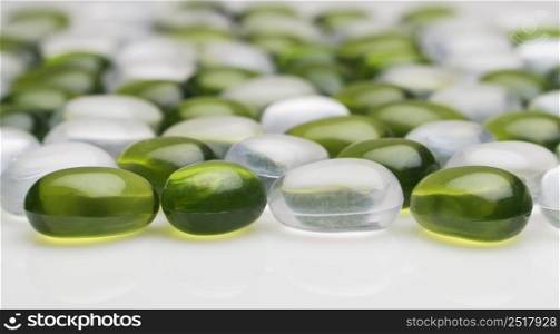 artificial round stones of green and white color. imitation pebbles. round plastic pebbles