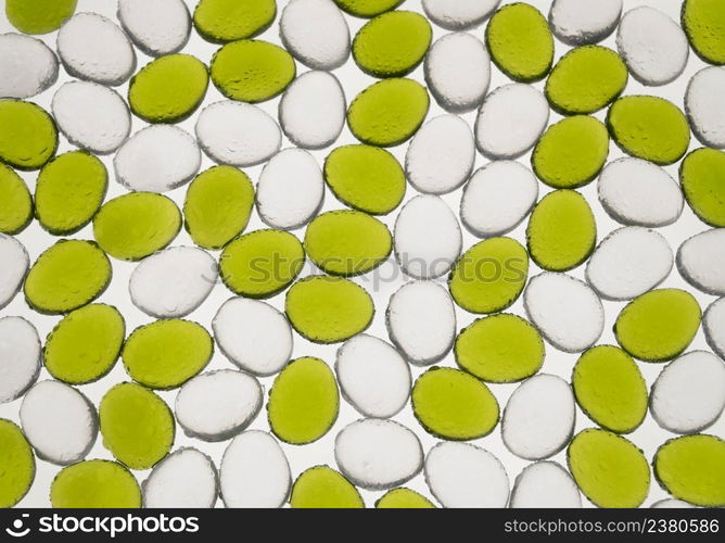 artificial round stones with water drop of green and white color, top view. imitation pebbles. round plastic pebbles