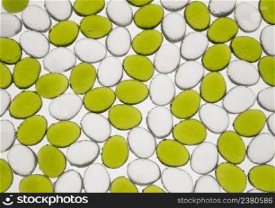 artificial round stones with water drop of green and white color, top view. imitation pebbles. round plastic pebbles