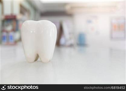 Artificial teeth model on wood table with blur background&#xA;