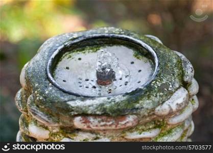 Artificial water spring in stoned tube and metal tap&#xA;