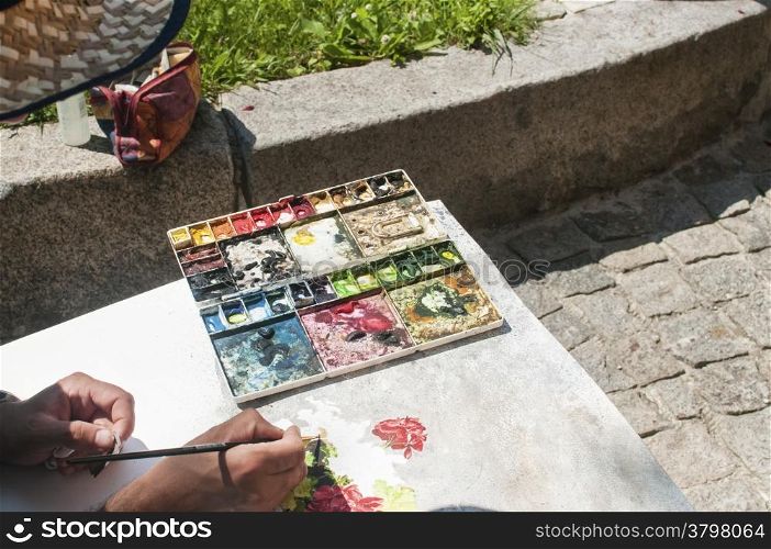 Artist at his watercolor painting workplace outdoor
