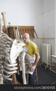 Artist drawing skeleton in studio