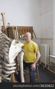 Artist drawing skeleton in studio