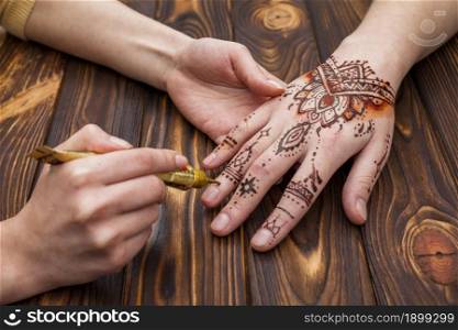 artist making mehndi womans hand. Resolution and high quality beautiful photo. artist making mehndi womans hand. High quality beautiful photo concept