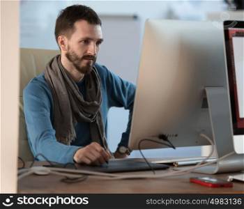 Artist or designer drawing something on graphic tablet at the office