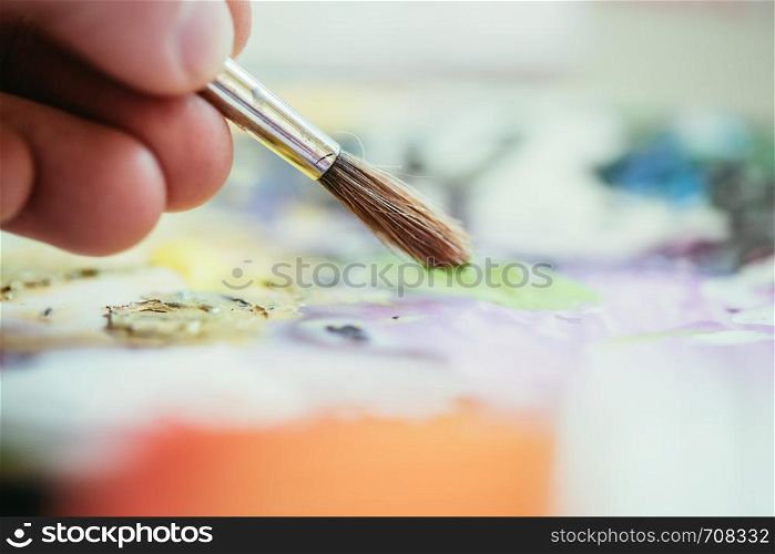 Artist paint brush on painting background. Painting therapy.