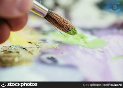 Artist paint brush on painting background. Painting therapy.