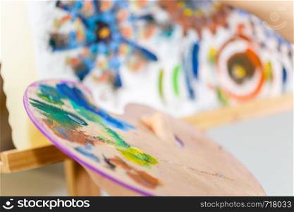 Artist painting art, selective focus close-up on palette