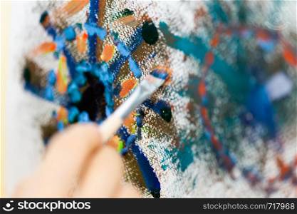 Artist painting, close-up on brush on canvas