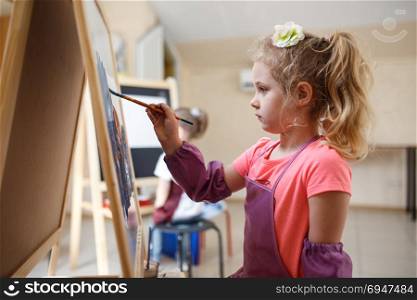 Artist school girl painting watercolor brush. Artist school girl painting watercolor brush in workshop