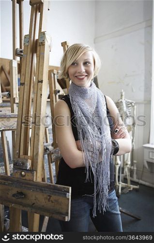 Artist standing among easels in studio