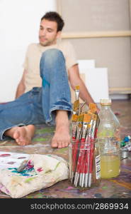 Artist With Painting Tools on Floor of Studio