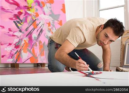 Artist Working on Canvas on Floor of Studio
