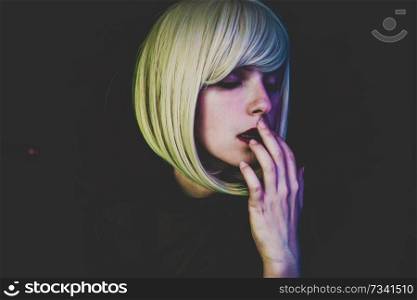 Artistic portrait of a sensual woman illuminated by colored lights