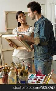 Artists Looking at Canvas in Studio