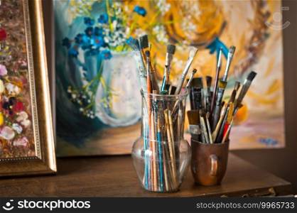 Artists workplace with a bunch of oil paint brushes.. Various brushes for oil paints on the table 2885.