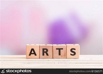 Arts sign headline on a wooden table