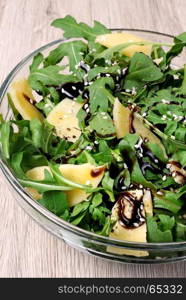 Arugula (rocket) salad dressed with balsamic soy sauce , Parmesan shavings and freshly ground black pepper, sesame.