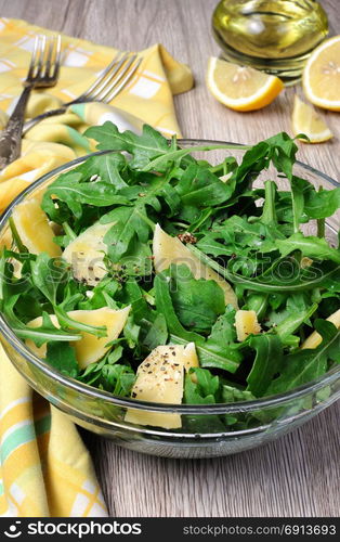 Arugula (rocket) salad dressed with balsamic soy sauce , Parmesan shavings and freshly ground black pepper, sesame.