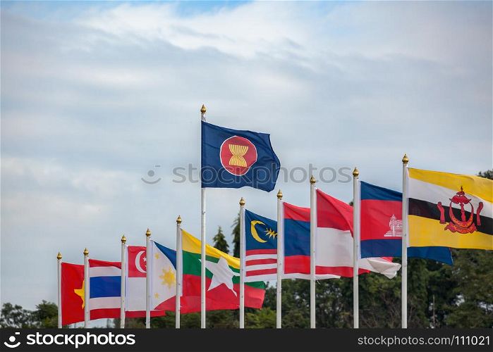ASEAN Economic Community flags, southeast asia countries and sky background