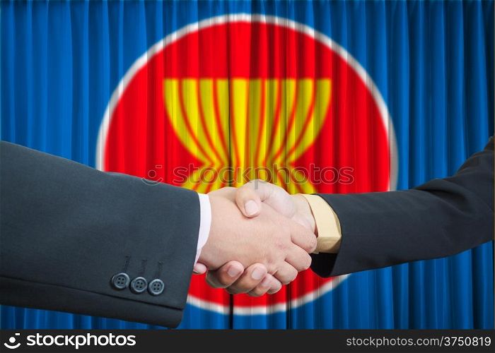 ASEAN Economic Community in businessman handshake
