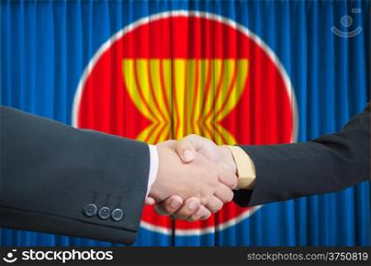 ASEAN Economic Community in businessman handshake