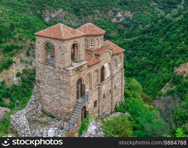 Asenovgrad, Bulgaria 24.07.2019. Church of the holy mother of God in the Asens Fortress surrounded Bulgarian Rhodope mountains on a cloudy summer day. Medieval Asens Fortress in Bulgaria