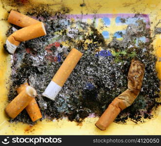 Ashtray full of cigarettes. Dirty tobacco texture