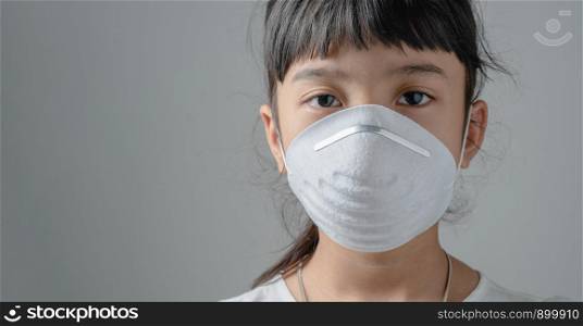 Asia child who have to wear a dust safety mask, Because the air is polluted and may cause her illness
