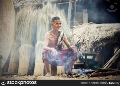 Asia citizen Old man uncle grandfather with old hot kettle / Man elderly serious living in the countryside of life rural people in thailand