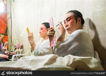 Asia / Thailand - August 28th 2019 : Chinese Opera Actress. Performers make up at backstage. . Asia / Thailand - August 28th 2019 : Chinese Opera Actress. Performers make up at backstage. Asian traditional cultural arts.