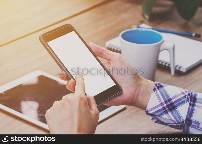 Asia woman hand holding and using phone in coffee shop.