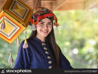 Asia woman thai style dress tribe Tai Dam / Portrait of beautiful young girl smiling Thailand traditional costume wearing with fabric woven on head