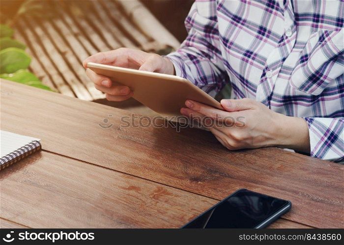 Asia woman using tablet on table in coffee shop