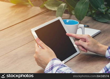 Asia woman using tablet on table in coffee shop