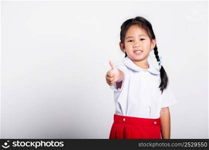 Asian adorable toddler smiling happy wear student thai uniform red skirt show thumb up finger in studio shot isolated on white background, Portrait little children girl preschool, Kid Back to school
