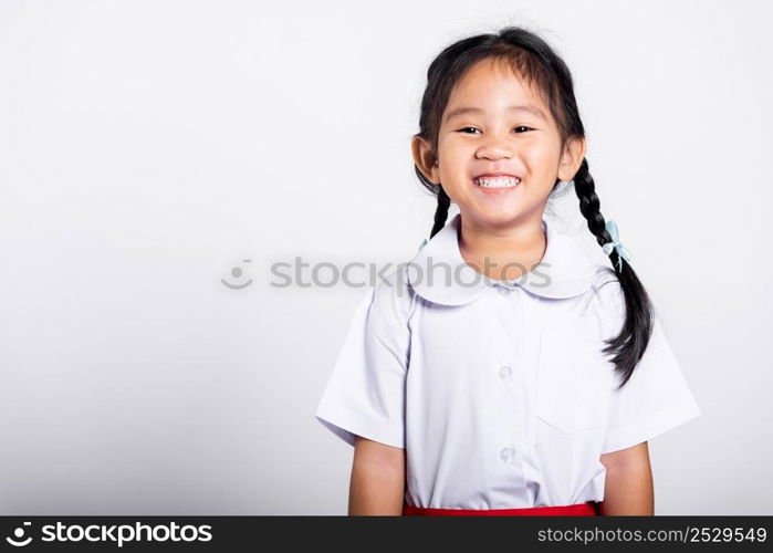 Asian adorable toddler smiling happy wearing student thai uniform red skirt standing in studio shot isolated on white background, Portrait little children girl preschool, Happy child Back to school