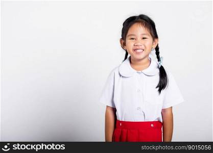 Asian adorable toddler smiling happy wearing student thai uniform red skirt standing in studio shot isolated on white background, Portrait little children girl preschool, Happy child Back to school