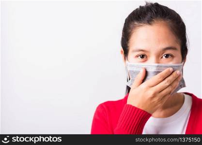 Asian adult woman wearing red shirt and face mask protective against coronavirus or COVID-19 virus or filter dust pm2.5 and air pollution her sneezing use hand close mouth, isolated white background