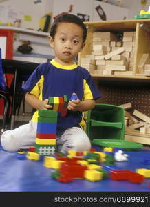 Asian American Boy Playing With Blocks And Looking Surprised