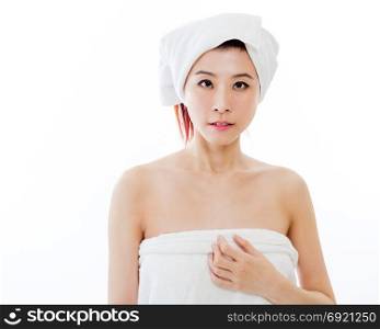 Asian American woman wrapped in towel on body and head