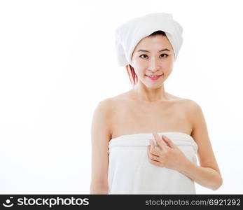 Asian American woman wrapped in towel on body and head