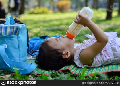 Asian baby girl eating milk from bottle, Breast feeding